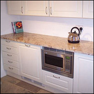 Kitchen showing granite worktops, storage and built-in appliances